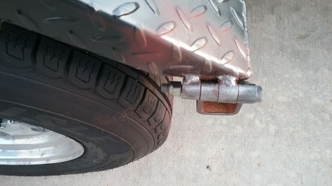 2016 Ford F-250 - A close-up view of a trailer's fender and tire, with a visible hinge attachment.