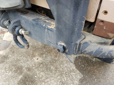 1988 Ford Bronco - Close-up of a tow hitch receiver assembly, a pin and clip securing a D-ring shackle.