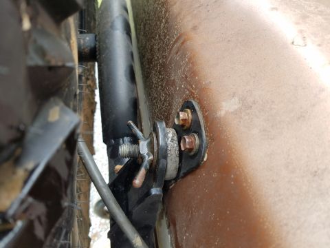 1988 Ford Bronco - Detail of a vehicle's suspension component, likely a shock mount.
