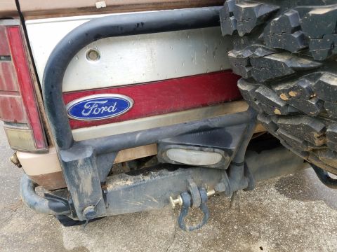 1988 Ford Bronco - Rear view of a 1988 Ford Bronco, showing the bumper, spare tire, and Ford emblem.