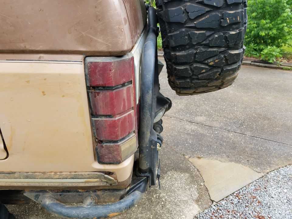 tail light and spare tire on back of a brown SUV