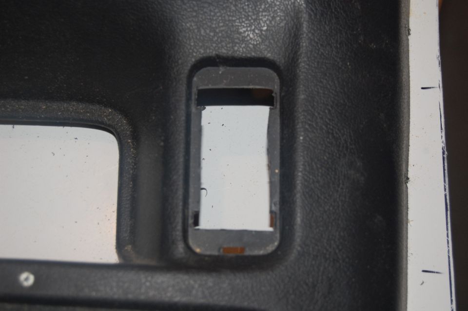Close-up of a black textured interior door panel with a rectangular cutout