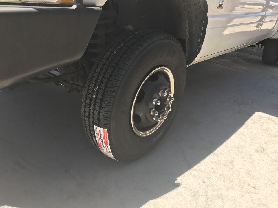 Close-up of a dually wheel and tire on a white Dodge 3500 pickup truck.