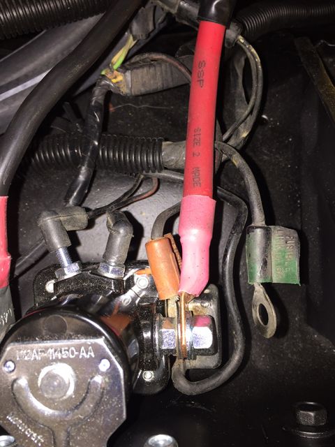 1978 Ford Bronco - A close-up view shows a starter solenoid with several wires connected, including a thick red wire with "SSP SIZE 2 100%" printed on it, and…