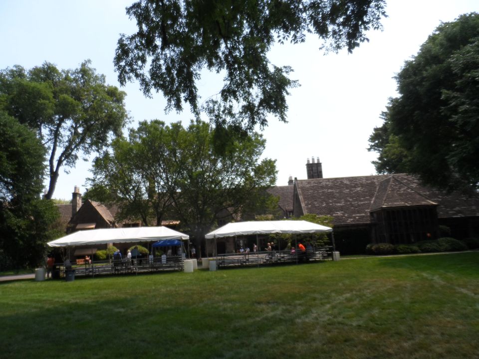 Building with tents and people on a lawn