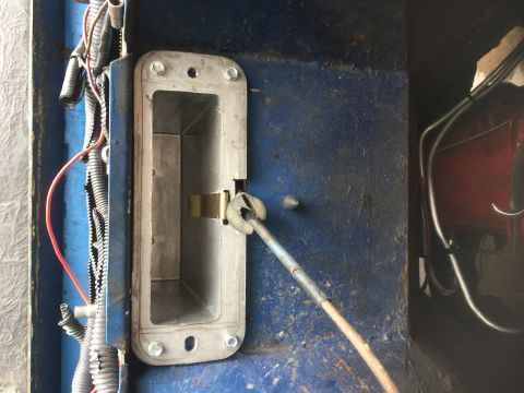 1974 Ford Bronco - Close-up of a metal latch mechanism with visible wiring and a rod. The Supermotors.net logo is in the corner.