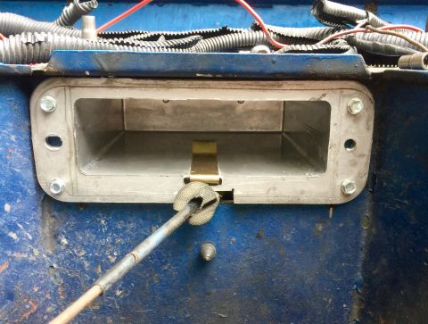 1974 Ford Bronco - Close-up view of an interior vehicle component, possibly related to a mechanism or housing, with visible wiring and a metal frame.