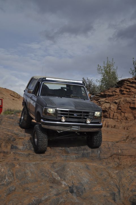 1991 Ford Bronco - This 1991 Ford Bronco navigates a challenging off-road course, its capabilities on a rocky trail.
