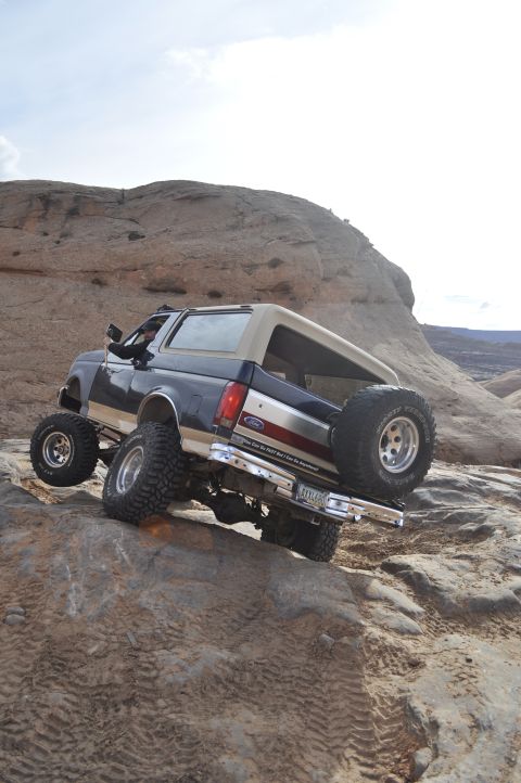 1991 Ford Bronco - 1991 Ford Bronco navigating a challenging rocky trail in Moab.