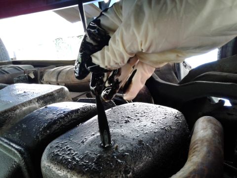 1984 Buick Electra - Checking engine oil level with a dipstick.