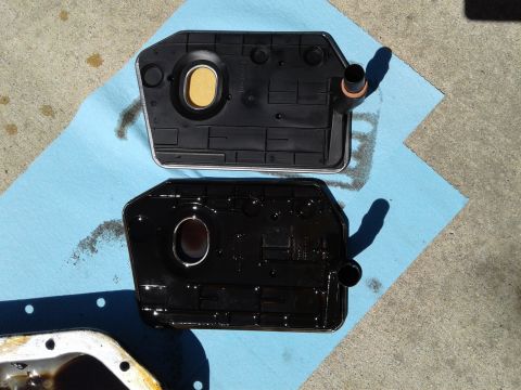 1984 Buick Electra - A clean transmission filter sits above a used one, indicating a fluid change.