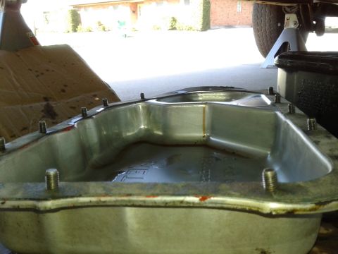 1984 Buick Electra - Oil pan removed from a vehicle, likely for service or repair. A Supermotors.net logo is visible.