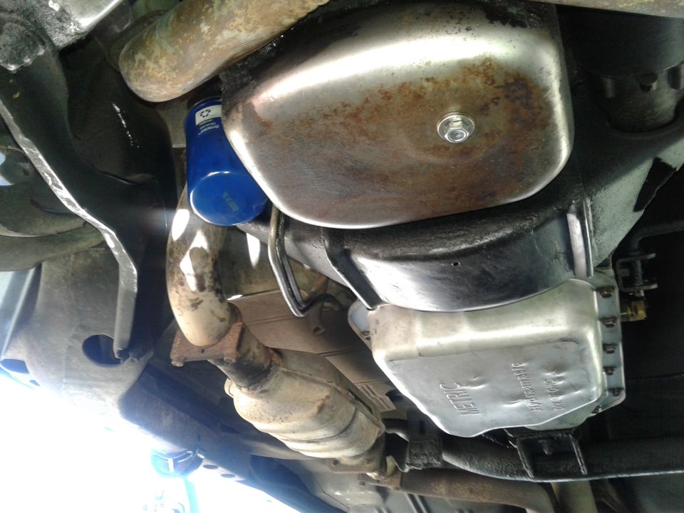 Undercarriage of a car showing oil pan, exhaust, and oil filter
