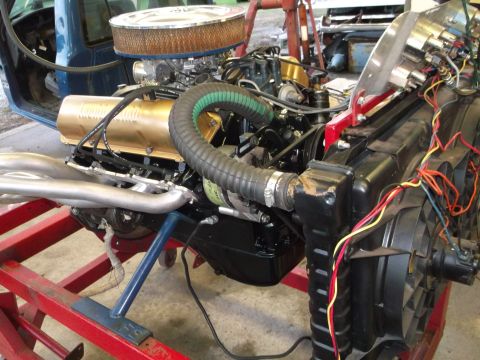 1964 Ford Galaxie - Engine assembly with a large air filter and radiator, wired for testing.