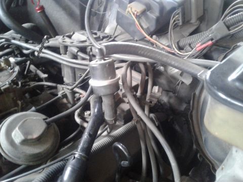 1984 Buick Electra - Engine bay detail showing vacuum lines and electrical connectors, no specific vehicle identified.