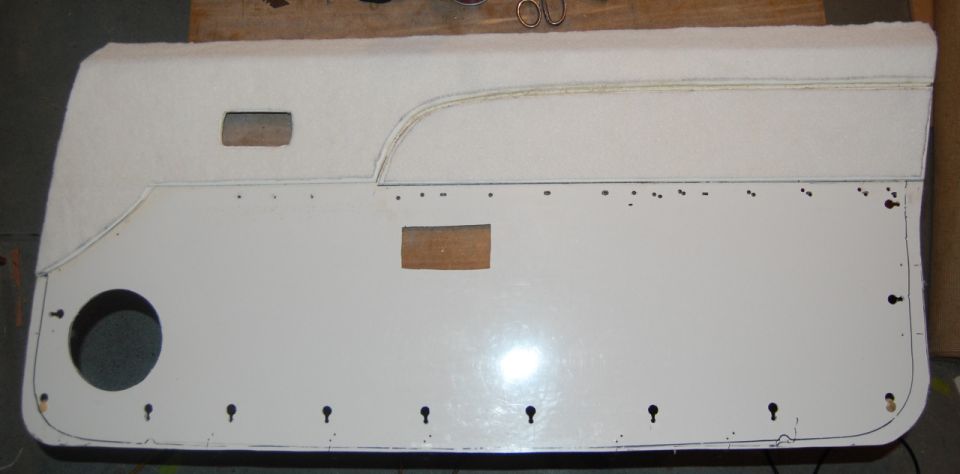 White car door panel with speaker cutout and fluffy top trim