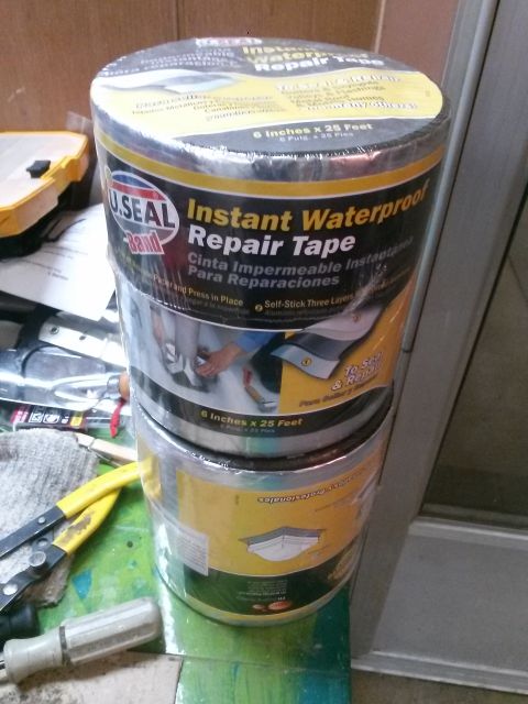 1996 Ford Bronco - Two rolls of U.Seal Band Instant Waterproof Repair Tape are stacked on top of each other. The tape is black and silver with yellow and whit…
