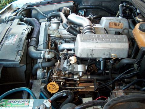 2001 Ford Crown Victoria - Close-up view of a diesel engine bay, showing various components and an Interstate battery.
