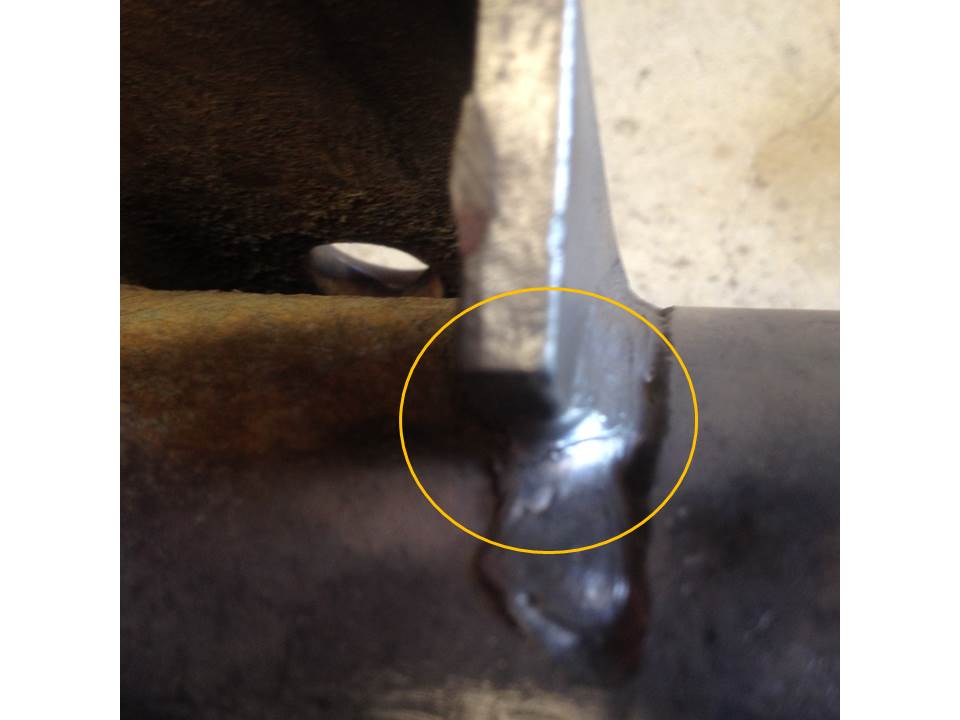 Close-up of a cracked metal part, possibly from a 1979 Ford Bronco.