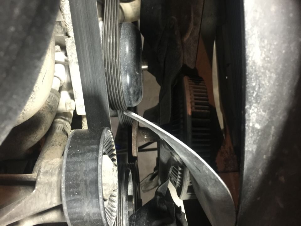 Serpentine belt and tensioner pulley on a 1996 Ford Bronco engine.