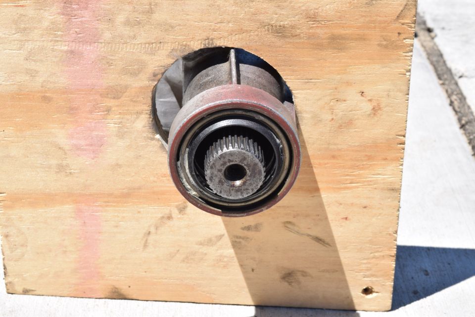 Splined shaft protruding from a wooden crate.