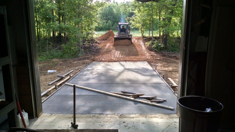 While the concrete was curing, the gravel arrived.  There's also a large gravel turning/parking area on the other side of the building.