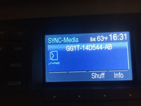 2013 Ford Taurus - The infotainment screen shows media information and external temperature, but no year is visible.