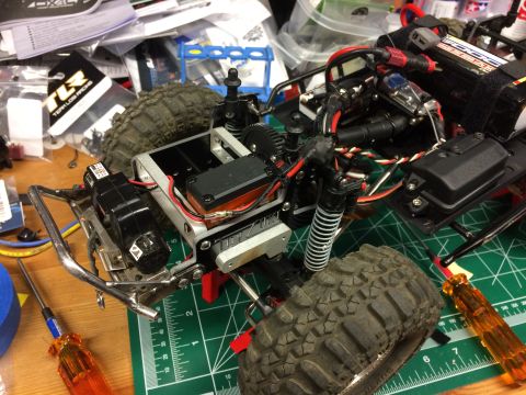 1989 Ford Bronco - Close-up view of an RC car's chassis, showing its intricate suspension and electrical wiring.