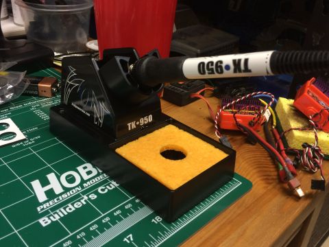 1989 Ford Bronco - A soldering iron and various electronic components for RC cars are laid out on a workbench.