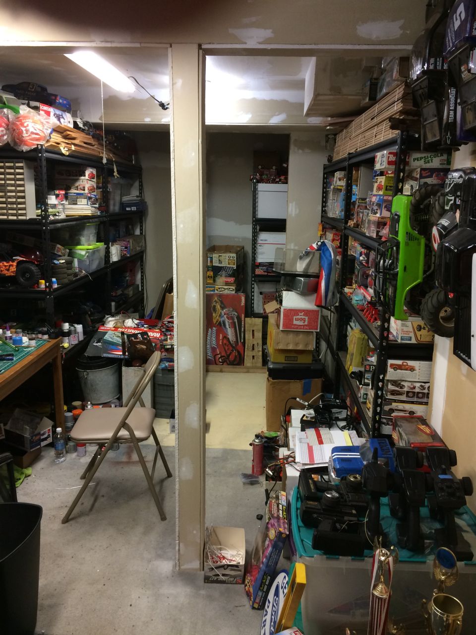 Storage room filled with shelves of RC car parts and boxes