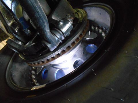 1992 Ford Bronco - Detailed view of a vehicle's wheel assembly, showing the brake system and suspension linkage.