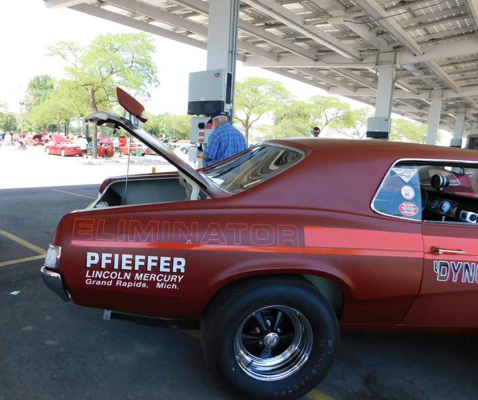 Rear view of a red 1968 Mercury Cougar with 'ELIMINATOR' and dealer text