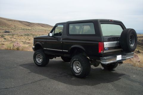 1995 Ford Bronco - This lifted 1995 Ford Bronco is shown from a three-quarter rear view, a spare tire mounted on the tailgate.
