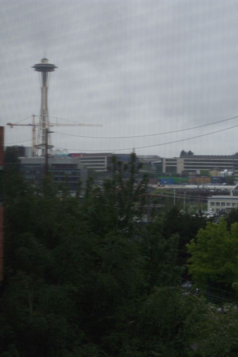 1995 Ford Bronco - View of Seattle's Space Needle and surrounding cityscape, including construction cranes and buildings, on an overcast day.