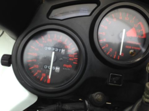 1989 Honda CBR600F - The motorcycle's dashboard displays the odometer reading of 83,312 miles and the tachometer.