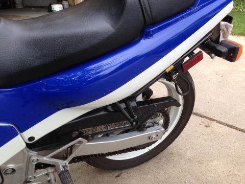 1989 Honda CBR600F - Close-up of a motorcycle's rear section, showing the seat, wheel, and chain drive.