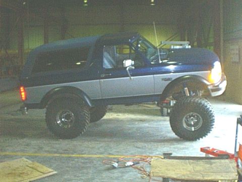 1995 Ford Bronco - This lifted SUV features a two-tone paint scheme and a removable soft top, its off-road capabilities.