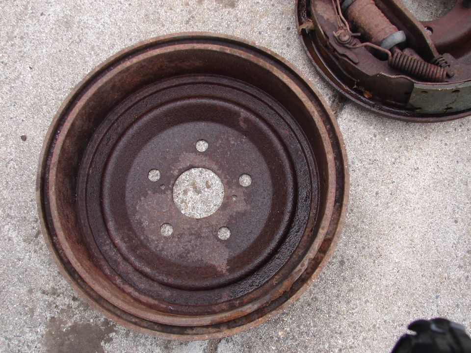 Rusty brake drum and brake shoes on concrete