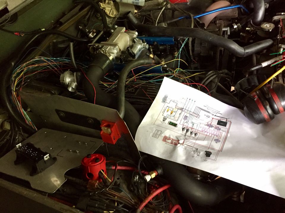 Working on the wiring. I have the main relay and fuel pump relay half wired in this picture. You can see the wiring diagram I created (based on a Megasquirt diagram) that I'm using to wire everything. I only have 30 or so more wires to connect before I can test everything. Not too shabby.