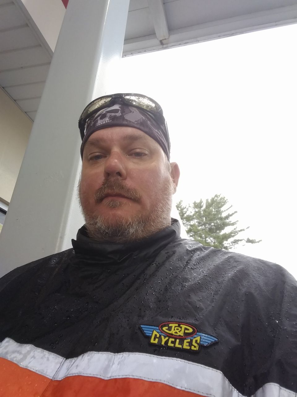 Man wearing a bandana, goggles, and a J&P Cycles jacket.