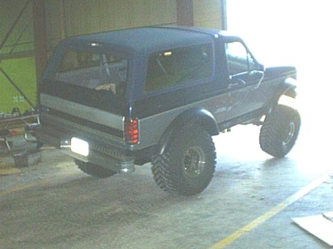 1995 Ford Bronco - This lifted Ford Bronco has a dark blue soft top and a two-tone paint scheme.