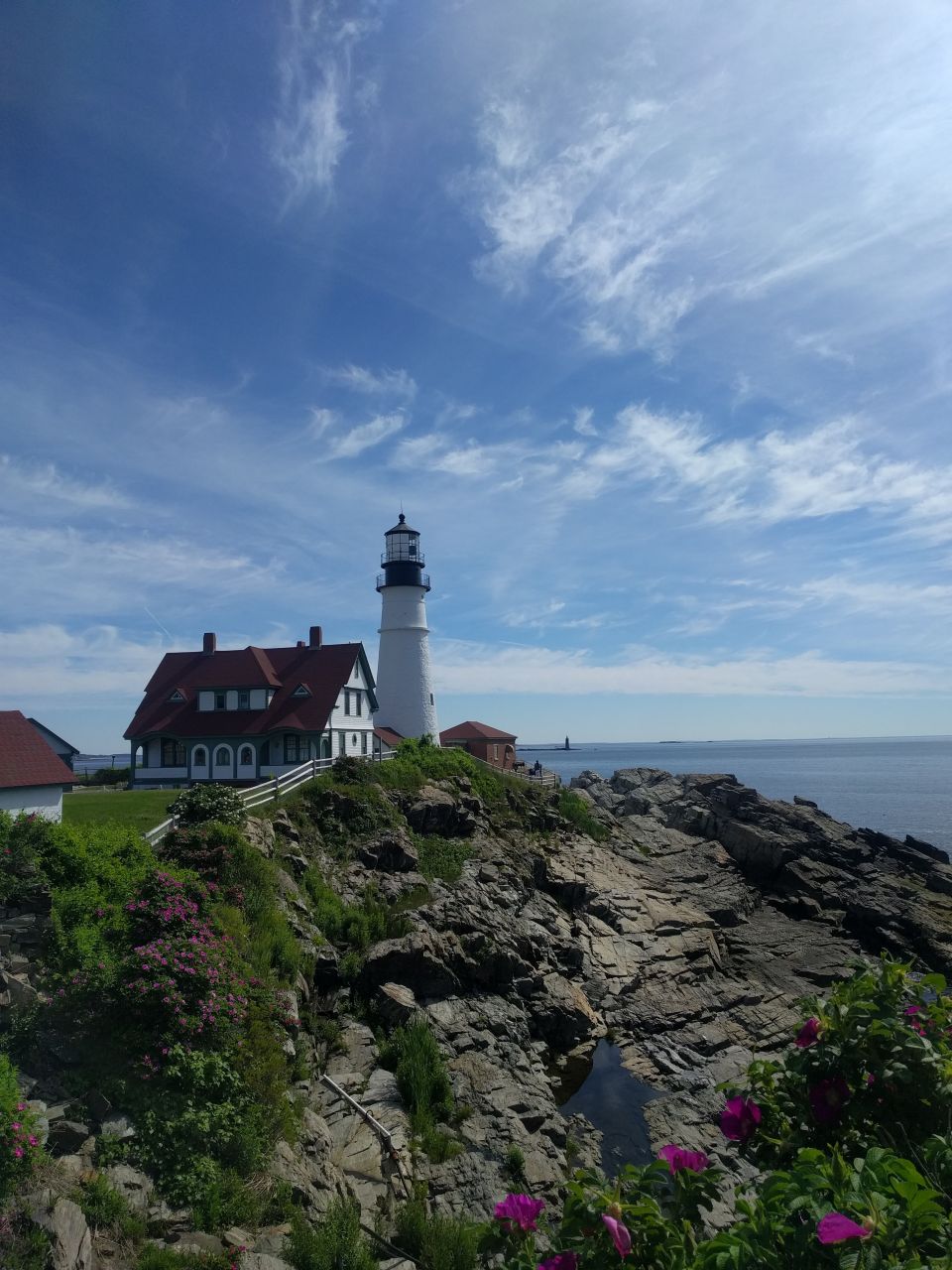 Lighthouse and keeper's house on a rocky coast.