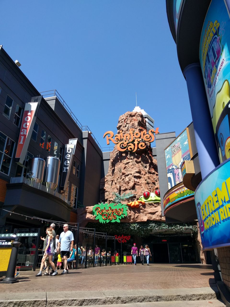 Rainforest Cafe building facade with people walking on the sidewalk