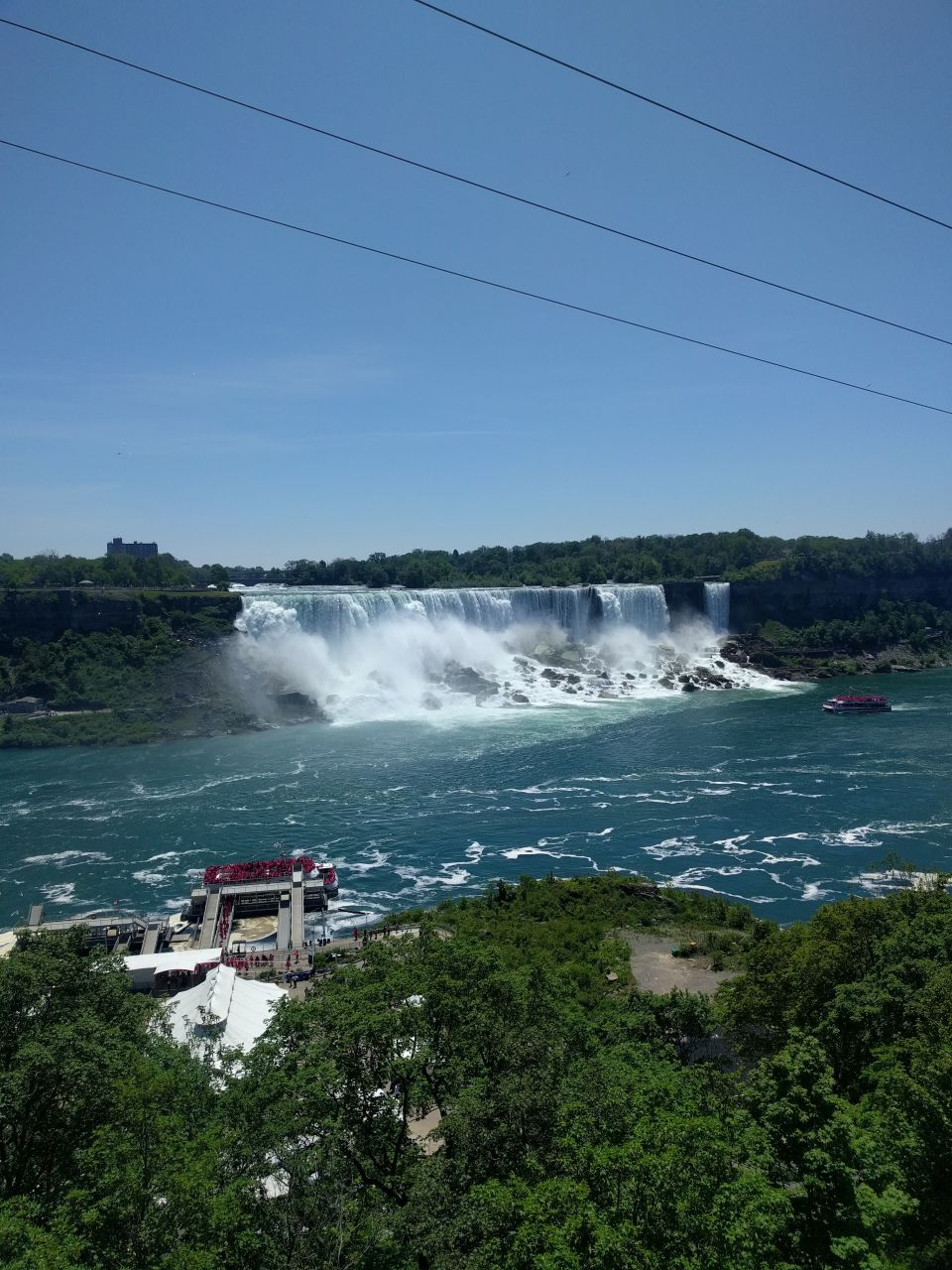 Niagara Falls with tour boats and trees
