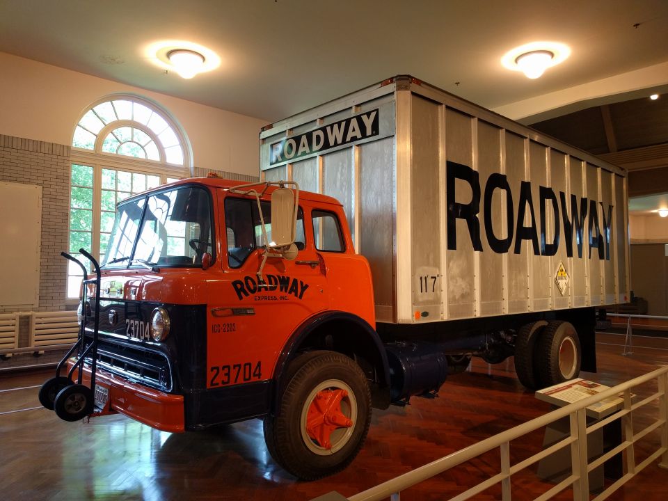 Vintage orange and navy blue Roadway Express truck with a silver trailer.