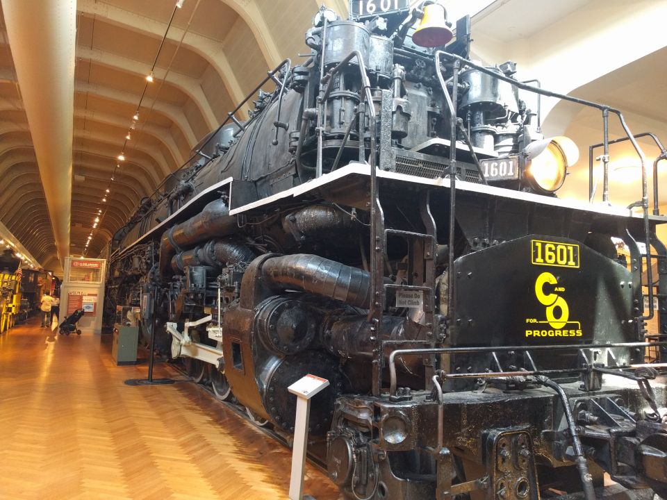 Black steam locomotive number 1601 on display indoors.