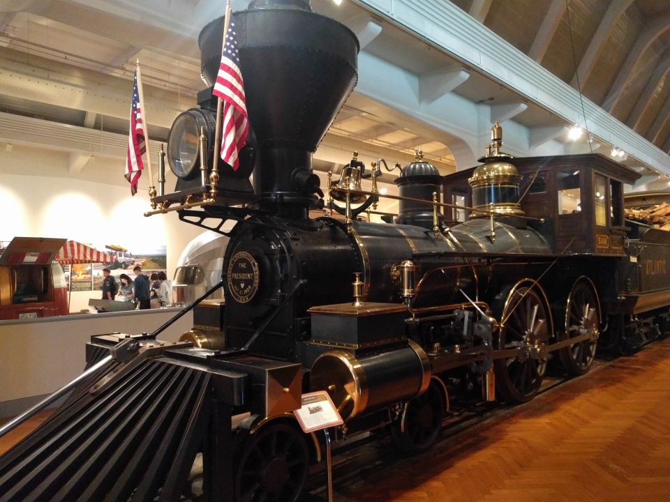 Historic black steam locomotive "The President" with American flags