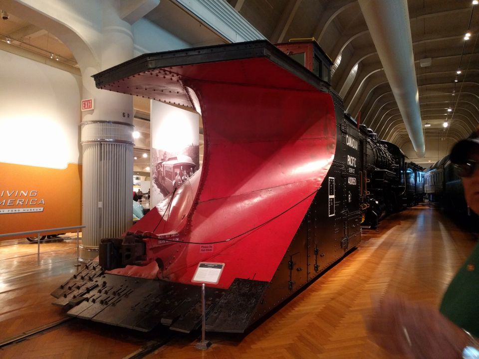 Canadian Pacific steam locomotive with red snowplow in a museum.