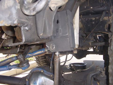1991 Ford Bronco - Close-up view of the vehicle's undercarriage, showing modified suspension parts.