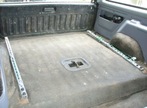 1992 Ford Bronco - Moving ahead with the uni-strut tie-downs idea. Need to add bolts at the back to pull them down flush.